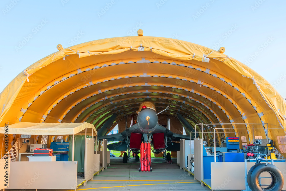 Wall mural air force fighter jet in the parking lot in the mobile hangar tactical base, rapidly deployable comp