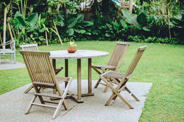 Wooden table and chairs in garden
