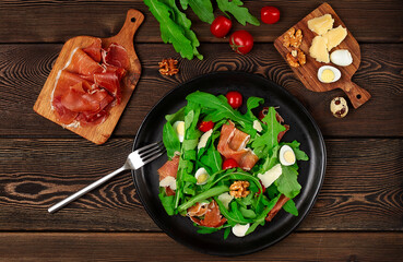 Salad, arugula leaves, with Parma prosciutto, cherry, quail eggs, healthy food, top view, horizontal, no people,