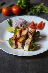 Cooked food paneer or grilled cottage cheese background. Close up, selective focus.