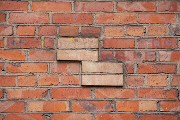 The texture of a fragment of a brick wall with a four-sided rectangular projection