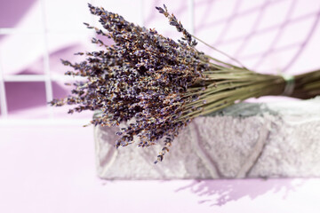 Still life with a bouquet of lavender on a light purple background with a copy of the space. Close-up. Space for text