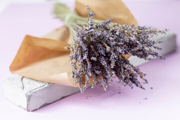 Still life with a bouquet of lavender on a light purple background with a copy of the space. Close-up. Space for text