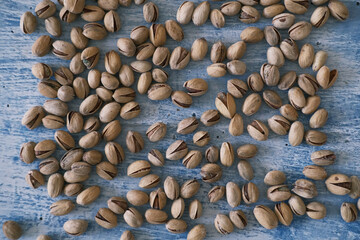 Top view of Salted and dried Pistachios on the Blurred painted stone table as background. Concept of healthy nutrition. Selective focus. Copy space.