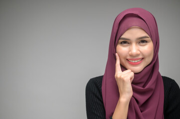 portrait of young muslim woman over white background studio