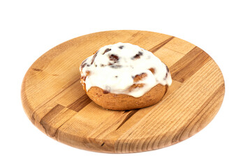 Freshly baked cinnabon cinnamon bun topped with sugar glaze.