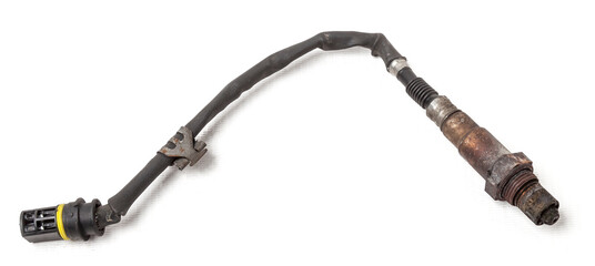 Lambda probe - oxygen sensor device designed to record tamount of remaining oxygen in the exhaust gas of car engine is located in exhaust system. Metal spare part for replacement to repair in workshop