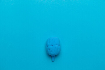 Human brain organ model on a blue background. Copy space for text.