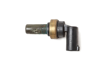Black coolant temperature sensor on a white background with yellow metal elements. The engine control unit corrective composition of the air-fuel mixture, the engine idle speed, the ignition timing.