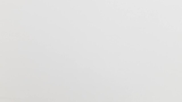 Stop Motion Animation_White paper ball unwrapping on yellow background