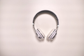 Close-up view of modern metallic headphones on white background