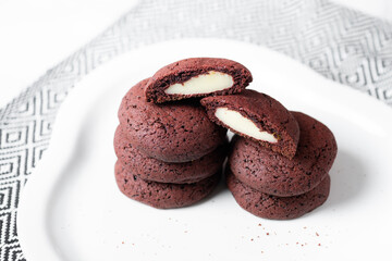 crunchy red velvet cookies set on white cafe table.