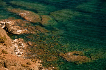 Fototapeta na wymiar top view of clear turquoise water of mediterranean sea on the shore