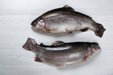 Raw fish on a white wooden background. Fish trout. Top view. Free space for your text.
