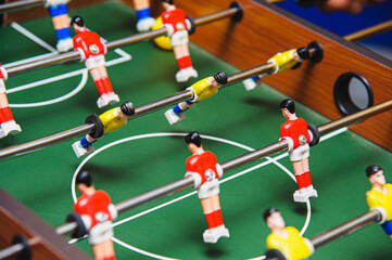 The game is table football. Teamwork concept. Selective focus. Analog leisure