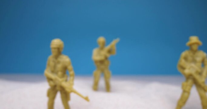 detailed extreme close-up. set of toy soldiers in the sand.