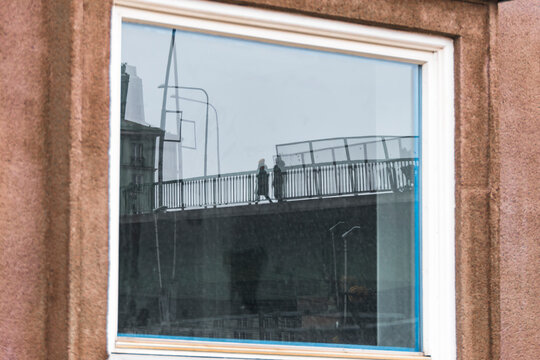 Stockholm, Sweden April 25, 2021 A reflection of pedestrians on Sankt Eriksbron, or Saint Eriks bridge.