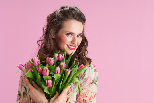 Portrait Of Smiling 40 Years Old Woman In Floral Dress On Pink