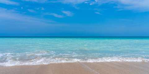 Classic panorama of the sea coast. Turquoise sea, blue sky and yellow sand