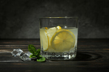 Glass of lemonade on wooden table, close up