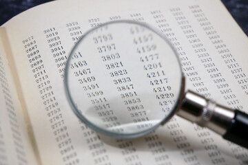 document with many numbers and magnifier, data encrypt. Cipher encryption code or data
