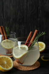 Glasses of lemonade on wooden background, space for text