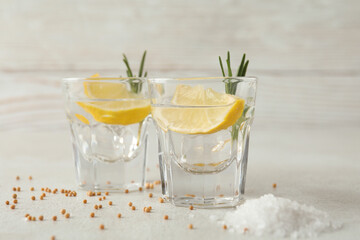 Shots of tequila on white textured table