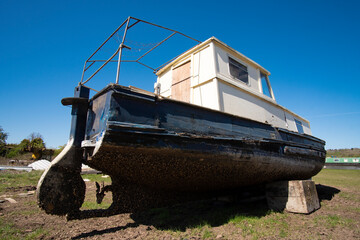 Aft view of an obsolete boat in a salvage yard © simonXT2