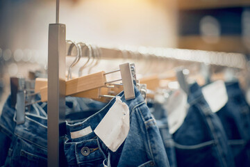 Fototapeta na wymiar Jeans on the hanger in the store. Shopping in store.