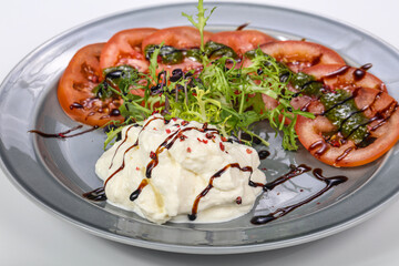 Strachatella cheese with tomato and rucola