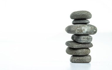 Pebble pyramid in balance are isolated on a white background. Stones pyramid symbolizing zen, harmony, balance.
