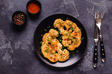 Cauliflower steak with spices cooked in the oven, top view.