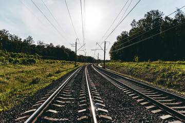railway landscape on a bright sunny summer day. rails going into the distance. rail turn. warm...