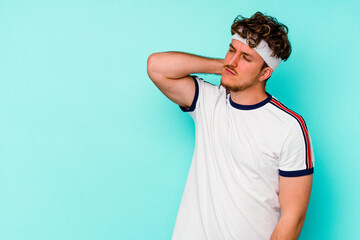 Young sport caucasian man isolated on blue background touching back of head, thinking and making a...