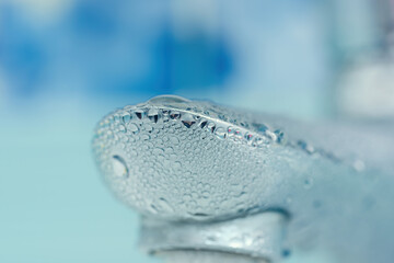 water drops on the faucet in the bathroom. Macro photo