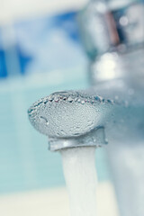 Naklejka na ściany i meble water drops on the faucet in the bathroom. Macro photo