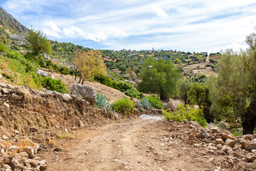 Dusty winding road on rocky slope in Rif mountains in the Morocco, North Africa