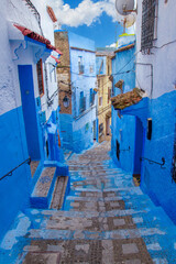 Narrow lane with steps in the blue medina of the Chefchaouen, Morocco. Blue city with traditional architecture in the Rif mountains of North Africa.