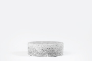 Cylinder shaped concrete podium isolated on white background.