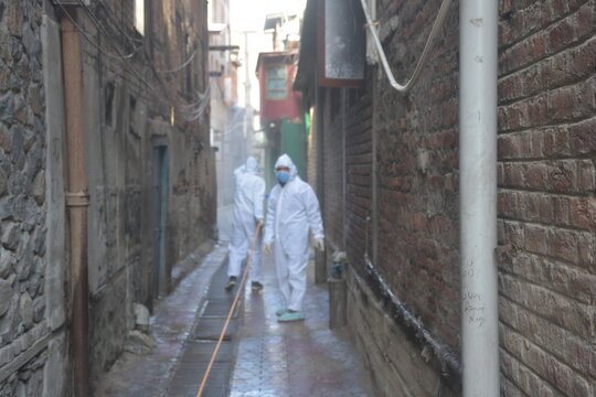 Covid Fumigation Vehicles Trucks And Frontline Heroes Wearing White Kits On Streets Empty Roads Of Srinagar City Kashmir India