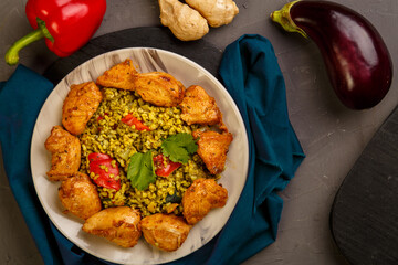 Food for suhoor in Ramadan bulgur fast with beef in a plate on a blue napkin next to vegetables.