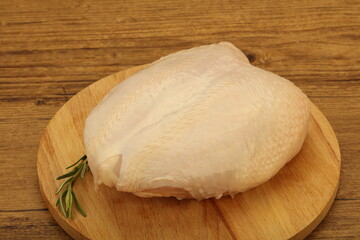 Raw whole chicken breast with skin