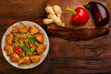 Food for suhoor in Ramadan bulgur post with beef in a plate on a wooden table.
