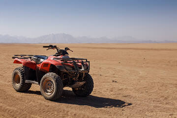 atv on the sand in desert © Krystsina
