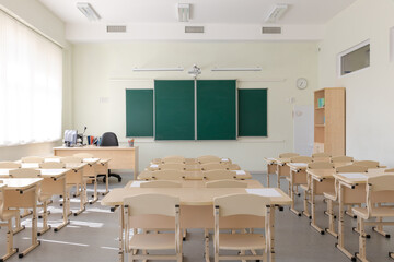 empty school class before final exams. Sheets for tests are laid out on the desks. overall plan