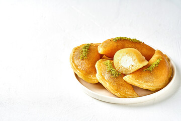 Traditional ramadan sweets qatayef. Arabic iftar food katayef with cheese. Closeup