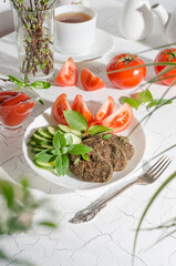 Raw cutlet made from vegetables and cereals with vegetables and herbs