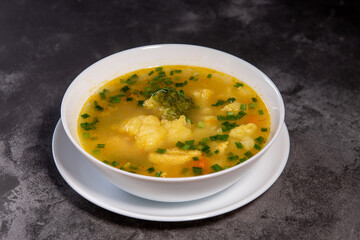 Vegetable soup. Ready-made vegetable lunch for lunch, hot soup for dinner at home. Soup with potatoes, carrots, broccoli, cauliflower and chicken fillet.