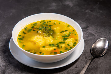Vegetable soup. Ready-made vegetable lunch for lunch, hot soup for dinner at home. Soup with potatoes, carrots, broccoli, cauliflower and chicken fillet.