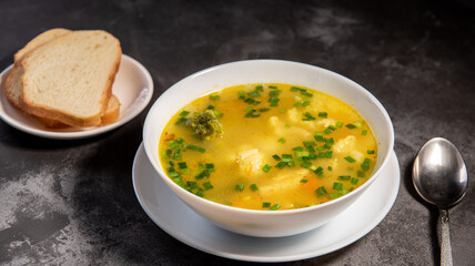 Vegetable soup. Serve the soup with bread. Ready-made vegetable lunch for lunch, hot soup for dinner at home. Soup with potatoes, carrots, broccoli, cauliflower and chicken fillet.